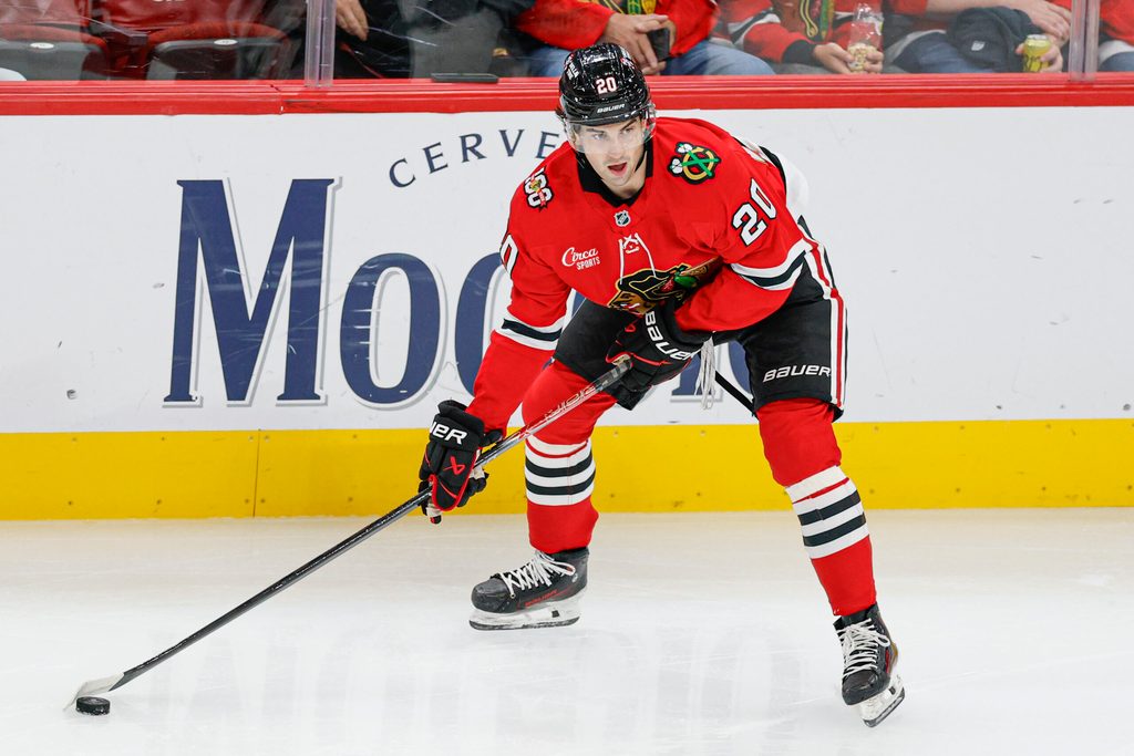 Oct 26, 2025; Chicago, Illinois, USA; Chicago Blackhawks center Ryan Greene (20) looks to pass the puck against the Los Angeles Kings during the second period at United Center. Mandatory Credit: Kamil Krzaczynski-Imagn Images