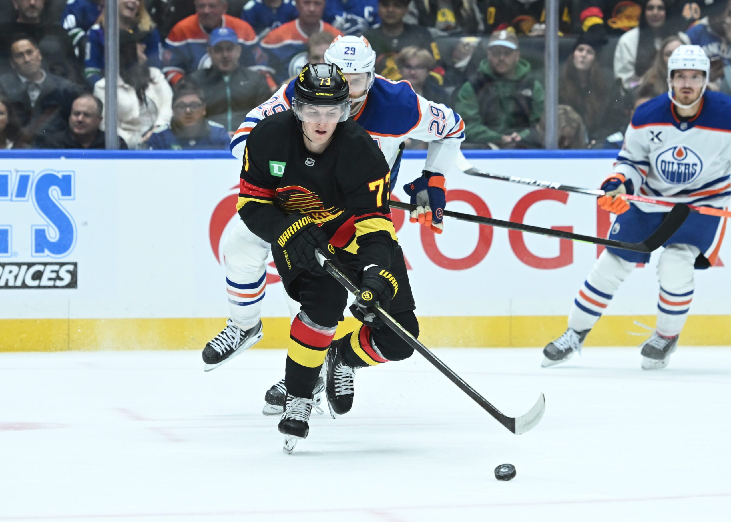 Oct 26, 2025; Vancouver, British Columbia, CAN;Vancouver Canucks left wing  Lucas Reichel (73) skates with the puck against Edmonton Oilers during the second period at Rogers Arena. Mandatory Credit: Simon Fearn-Imagn Images