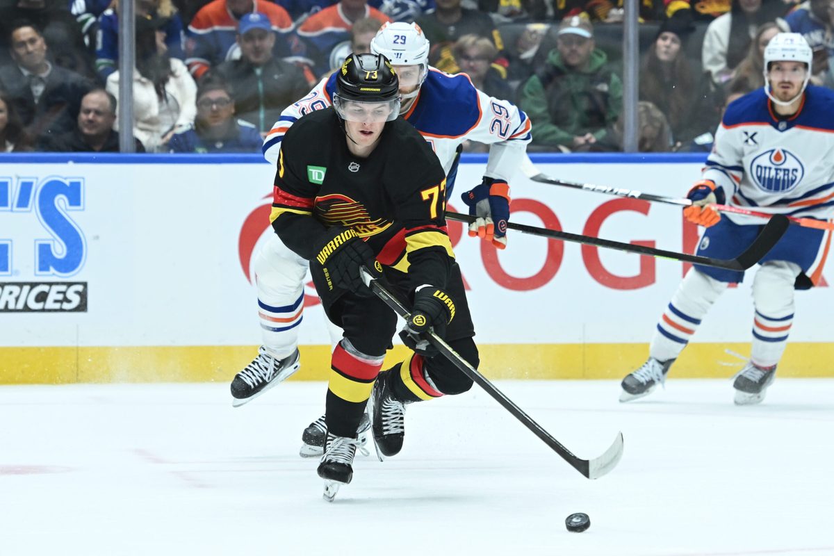 Oct 26, 2025; Vancouver, British Columbia, CAN;Vancouver Canucks left wing Lucas Reichel (73) skates with the puck against Edmonton Oilers during the second period at Rogers Arena. Mandatory Credit: Simon Fearn-Imagn Images