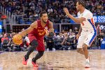 Oct 27, 2025; Detroit, Michigan, USA; Detroit Pistons forward Ronald Holland II (5) defends against Cleveland Cavaliers guard Donovan Mitchell (45) during the second half at Little Caesars Arena. Mandatory Credit: David Reginek-Imagn Images