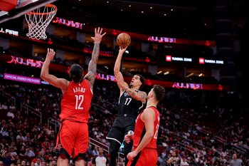 Oct 27, 2025; Houston, Texas, USA; Brooklyn Nets forward Michael Porter Jr. (17) shoots inside against Houston Rockets forward Tari Eason (17) during the third quarter at Toyota Center. Mandatory Credit: Erik Williams-Imagn Images