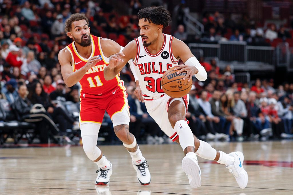 Oct 27, 2025; Chicago, Illinois, USA; Chicago Bulls guard Tre Jones (30) drives to the basket against Atlanta Hawks guard Trae Young (11) during the first half at United Center. Mandatory Credit: Kamil Krzaczynski-Imagn Images