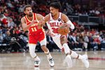 Oct 27, 2025; Chicago, Illinois, USA; Chicago Bulls guard Tre Jones (30) drives to the basket against Atlanta Hawks guard Trae Young (11) during the first half at United Center. Mandatory Credit: Kamil Krzaczynski-Imagn Images
