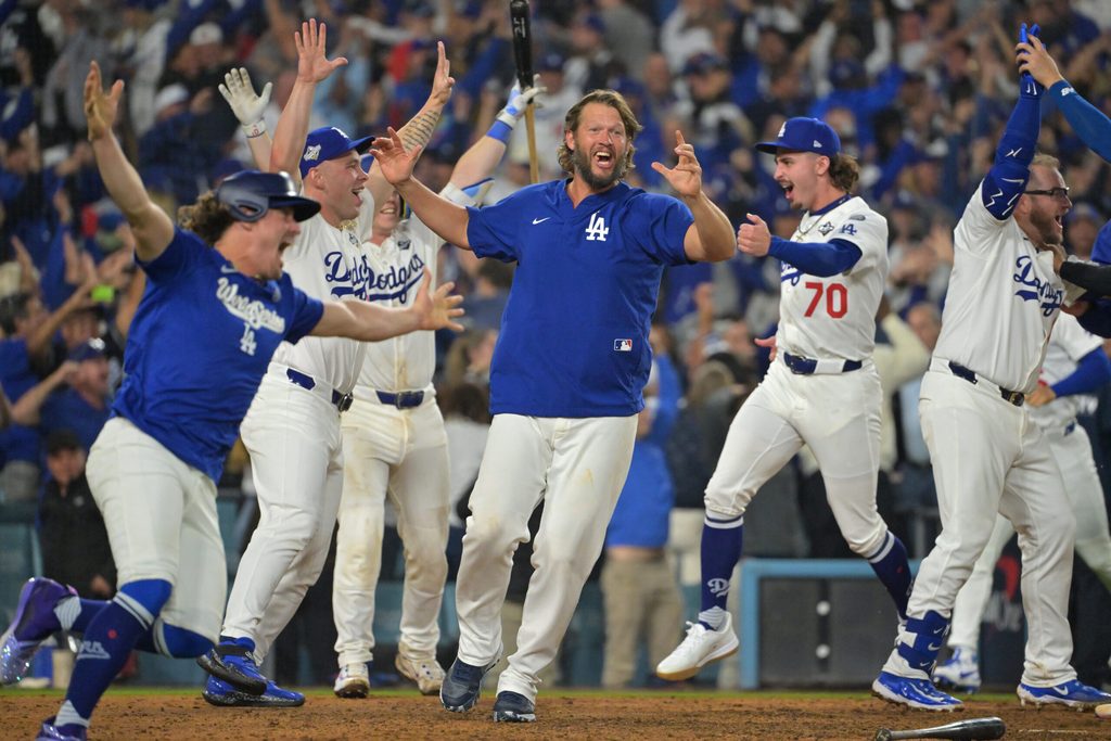 Oct 27, 2025; Los Angeles, California, USA; Los Angeles Dodgers pitcher Clayton Kershaw (22) celebrates with teammates after first baseman Freddie Freeman (5) hit a walk off home run against the Toronto Blue Jays in the eighteenth inning during game three of the 2025 MLB World Series at Dodger Stadium. Mandatory Credit: Jayne Kamin-Oncea-Imagn Images