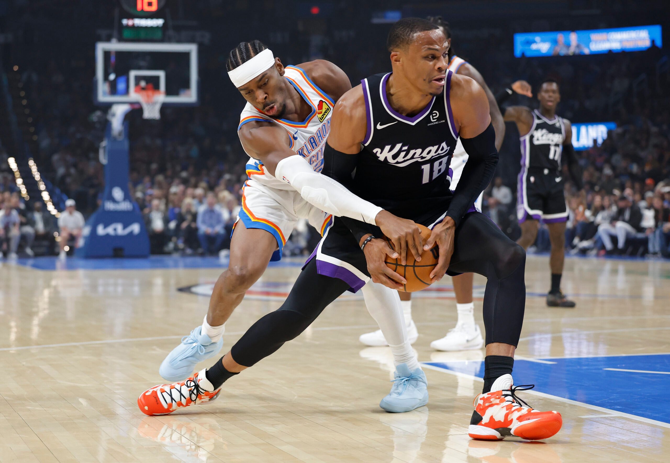 Oct 28, 2025; Oklahoma City, Oklahoma, USA; Oklahoma City Thunder guard Shai Gilgeous-Alexander (2) defends a drive by Sacramento Kings guard Russell Westbrook (18) during the first quarter at Paycom Center. Mandatory Credit: Alonzo Adams-Imagn Images