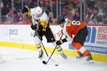 Oct 28, 2025; Philadelphia, Pennsylvania, USA; Pittsburgh Penguins center Evgeni Malkin (71) and Philadelphia Flyers defenseman Cam York (8) battle for the puck in overtime at Xfinity Mobile Arena. Mandatory Credit: Kyle Ross-Imagn Images