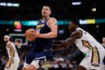 Oct 29, 2025; Denver, Colorado, USA; Denver Nuggets center Nikola Jokic (15) controls the ball under pressure form New Orleans Pelicans forward Zion Williamson (1) in the third quarter at Ball Arena. Mandatory Credit: Isaiah J. Downing-Imagn Images