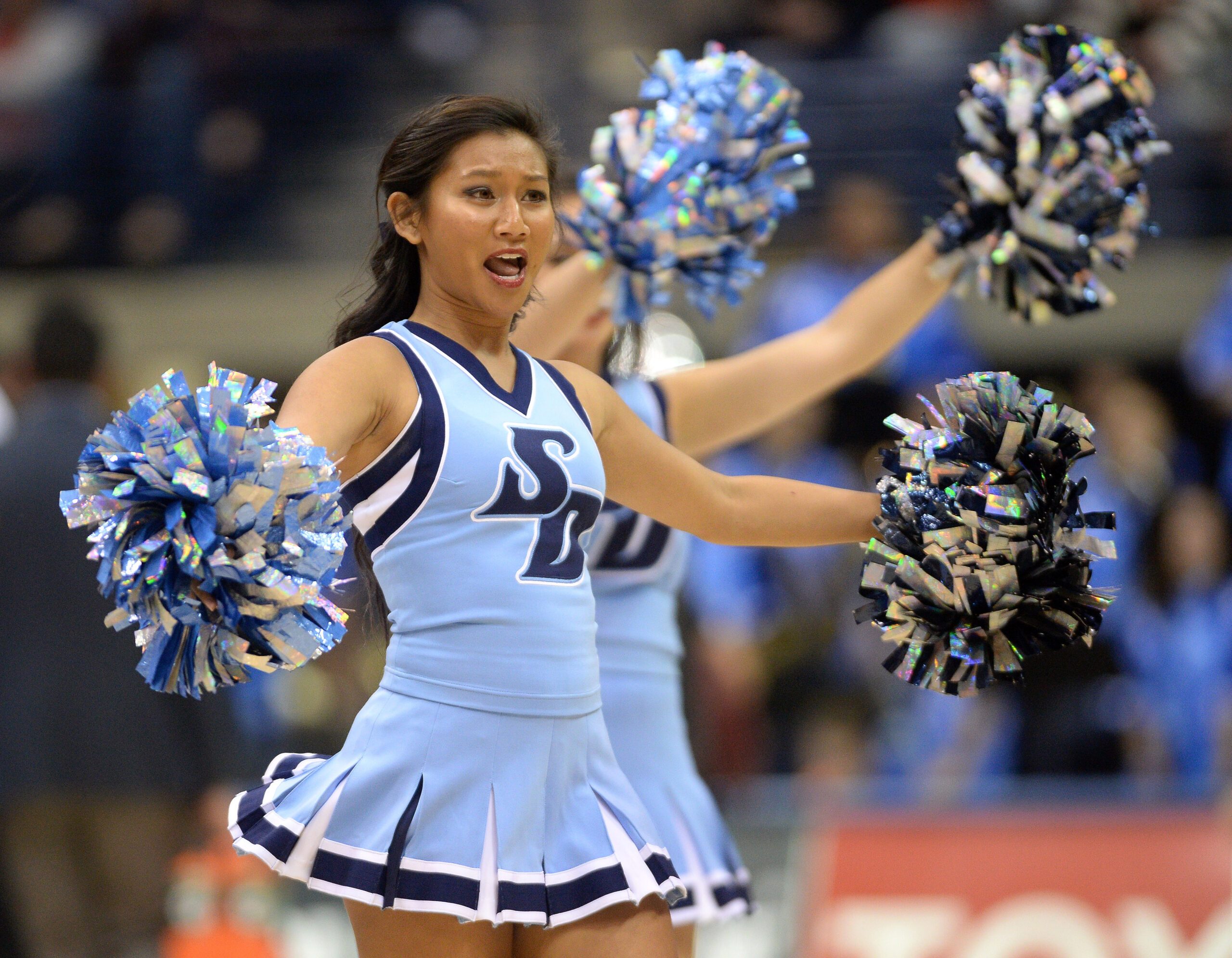 Nov 30, 2017; San Diego, CA, USA; San Diego Toreros cheerleaders perform during a pause in play during the second half of the game between the Toreros and the San Diego State Aztecs at Jenny Craig Pavilion. Mandatory Credit: Orlando Ramirez-Imagn Images
