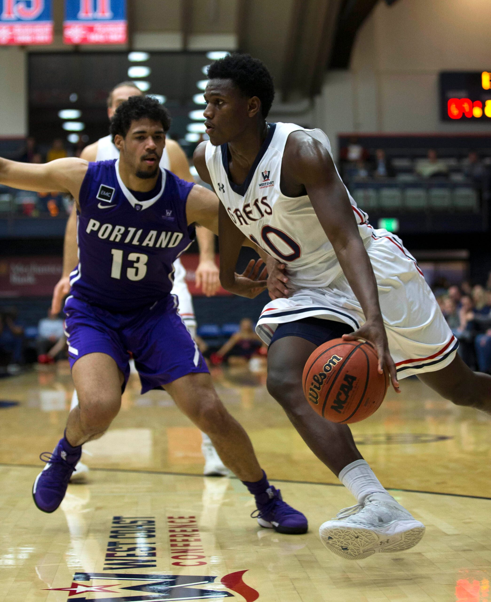 Jan 27, 2018; Moraga, CA, USA; Saint Mary's  player Elijah Thomas (10) drives past Portland Pilots player Franklin Porter (13) in the second half of an NCAA men's college basketball game at McKeon Pavilion. Mandatory Credit: D. Ross Cameron-Imagn Images