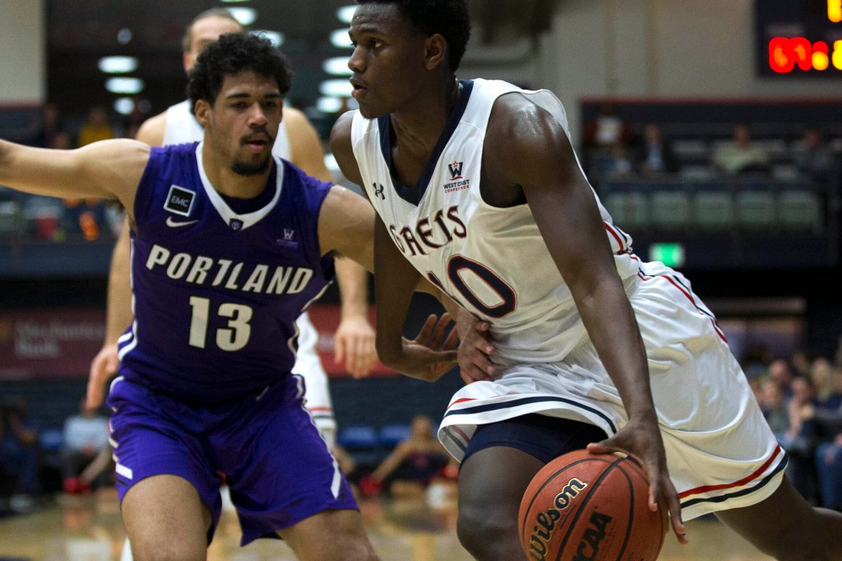 Jan 27, 2018; Moraga, CA, USA; Saint Mary's player Elijah Thomas (10) drives past Portland Pilots player Franklin Porter (13) in the second half of an NCAA men's college basketball game at McKeon Pavilion. Mandatory Credit: D. Ross Cameron-Imagn Images