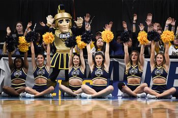Mar 15, 2018; Boise, ID, USA; UNC-Greensboro Spartans cheerleaders and mascot cheer from courtside in the first half between the UNC-Greensboro Spartans and the Gonzaga Bulldogs during the first round of the 2018 NCAA Tournament at Taco Bell Arena. Mandatory Credit: Kyle Terada-Imagn Images