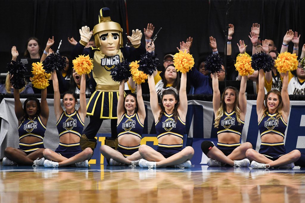 Mar 15, 2018; Boise, ID, USA; UNC-Greensboro Spartans cheerleaders and mascot cheer from courtside in the first half between the UNC-Greensboro Spartans and the Gonzaga Bulldogs during the first round of the 2018 NCAA Tournament at Taco Bell Arena. Mandatory Credit: Kyle Terada-Imagn Images