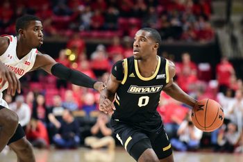 Dec 29, 2019; College Park, Maryland, USA; Bryant Bulldogs guard Ikenna Ndugba (0) dribbles while being defended by Maryland Terrapins guard Darryl Morsell (11) in the first half at XFINITY Center. Mandatory Credit: Evan Habeeb-Imagn Images