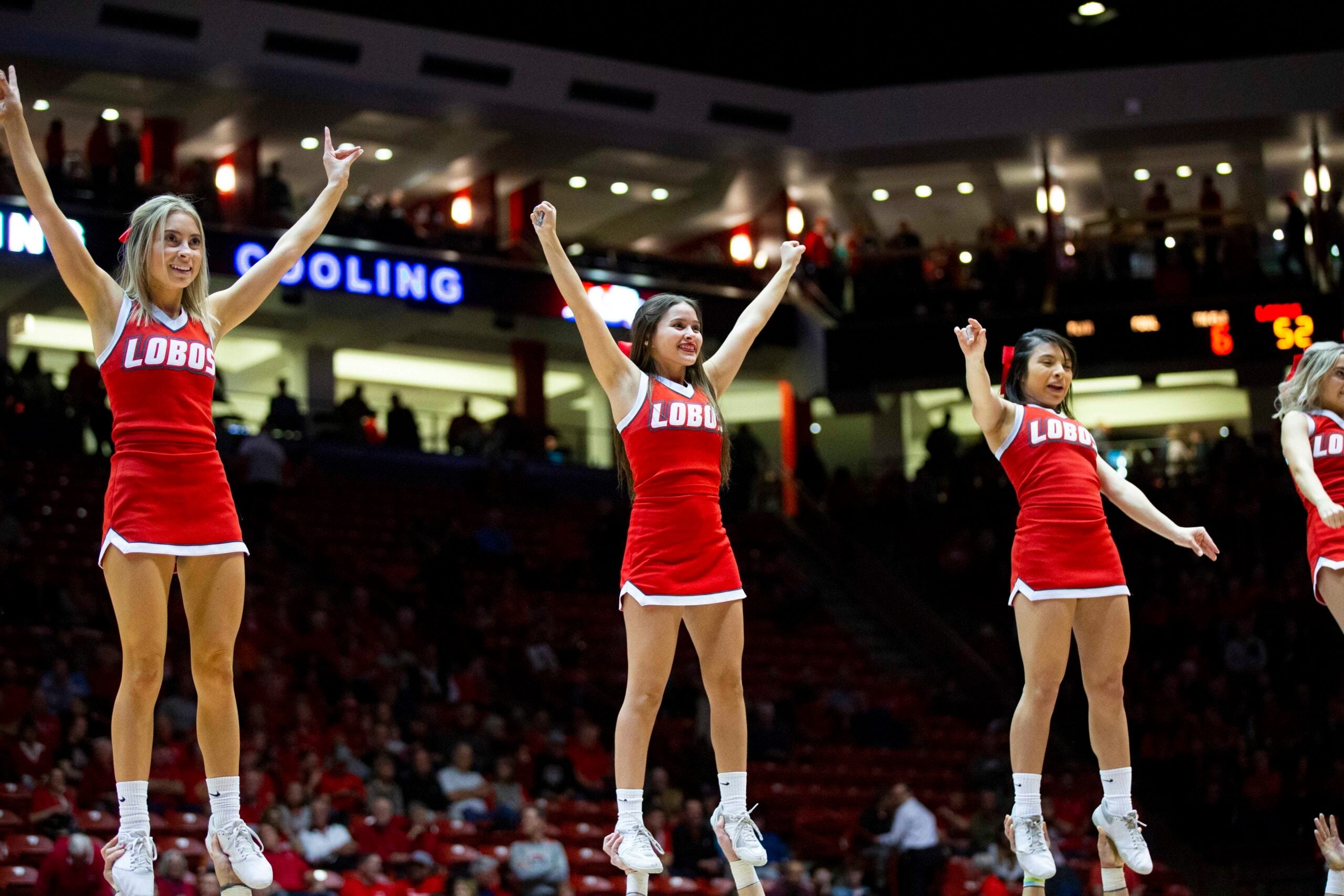 Jan 29, 2020; Albuquerque, New Mexico, USA;  The New Mexico State cheerleading squad perform during a timeout as the Lobos face the San Diego State Aztecs during the second half at Dreamstyle Arena. Mandatory Credit: Ivan Pierre Aguirre-Imagn Images