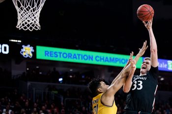 Cincinnati Bearcats center Chris Vogt (33) misses a shot over Wichita State Shockers center Jaime Echenique (21) in the second half of the NCAA men's basketball game on Sunday, Feb. 23, 2020, in Fifth Third Arena at the University of Cincinnati. Cincinnati Bearcats defeated Wichita State Shockers 67-64.

Cincinnati Bearcats Wichita State Shockers 243