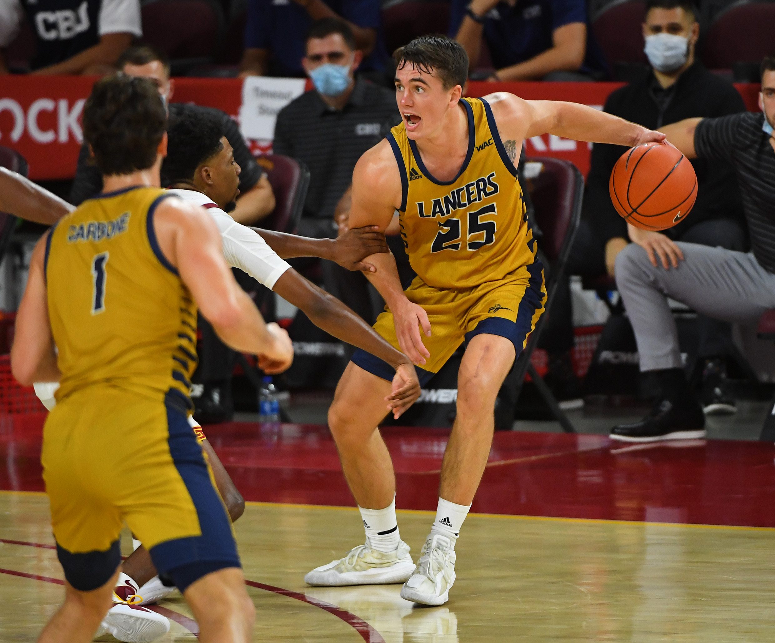 Nov 25, 2020; Los Angeles, California, USA;  California Baptist Lancers guard Ty Rowell (25) drives against the USC Trojans in the second half at the Galen Center. Mandatory Credit: Jayne Kamin-Oncea-Imagn Images