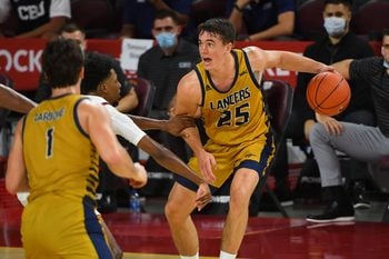 Nov 25, 2020; Los Angeles, California, USA;  California Baptist Lancers guard Ty Rowell (25) drives against the USC Trojans in the second half at the Galen Center. Mandatory Credit: Jayne Kamin-Oncea-Imagn Images