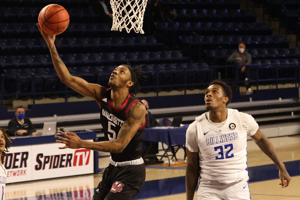 Mar 5, 2021; Richmond, Virginia, USA; Massachusetts Minutemen guard Cairo McCrory (5) shoots the ball as Saint Louis Billikens forward Jimmy Bell Jr. (32) looks on in the first half of a quarterfinal in the Atlantic 10 conference tournament at Robins Center. Mandatory Credit: Geoff Burke-Imagn Images
