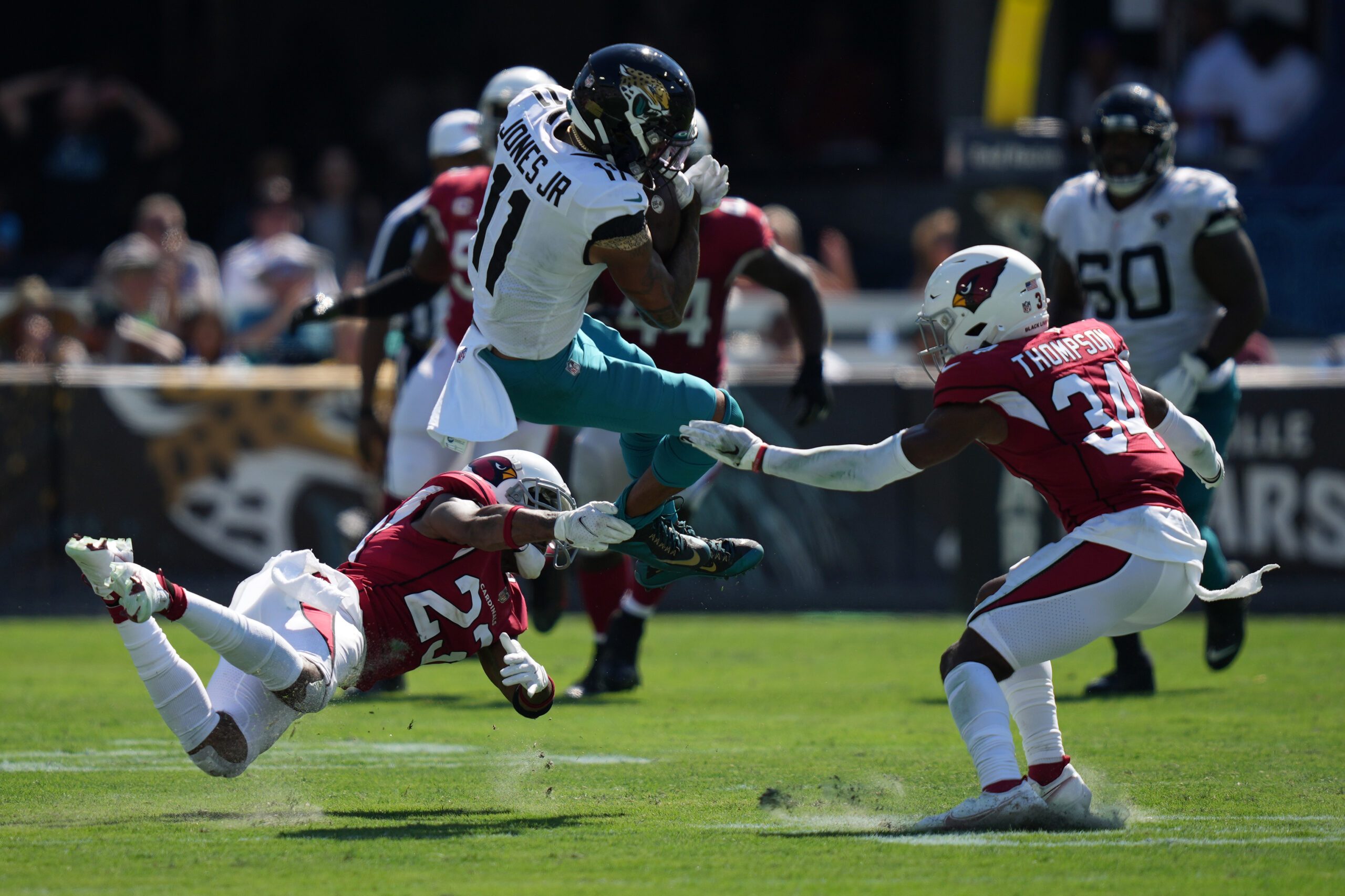Sep 26, 2021; Jacksonville, Florida, USA; Arizona Cardinals cornerback Robert Alford (23) brings down Jacksonville Jaguars wide receiver Marvin Jones (11) during the second half at TIAA Bank Field. Mandatory Credit: Jasen Vinlove-Imagn Images
