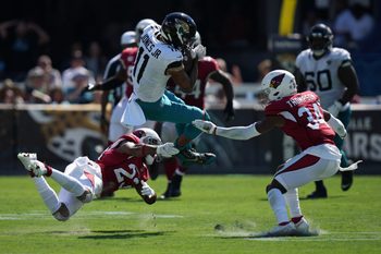 Sep 26, 2021; Jacksonville, Florida, USA; Arizona Cardinals cornerback Robert Alford (23) brings down Jacksonville Jaguars wide receiver Marvin Jones (11) during the second half at TIAA Bank Field. Mandatory Credit: Jasen Vinlove-Imagn Images