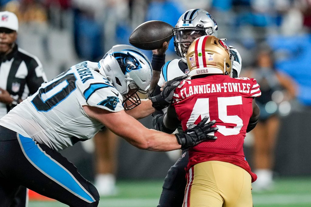 Oct 9, 2022; Charlotte, North Carolina, USA; Carolina Panthers quarterback PJ Walker (11) is sacked by San Francisco 49ers linebacker Demetrius Flannigan-Fowles (45) during the second half at Bank of America Stadium. Mandatory Credit: Jim Dedmon-Imagn Images
