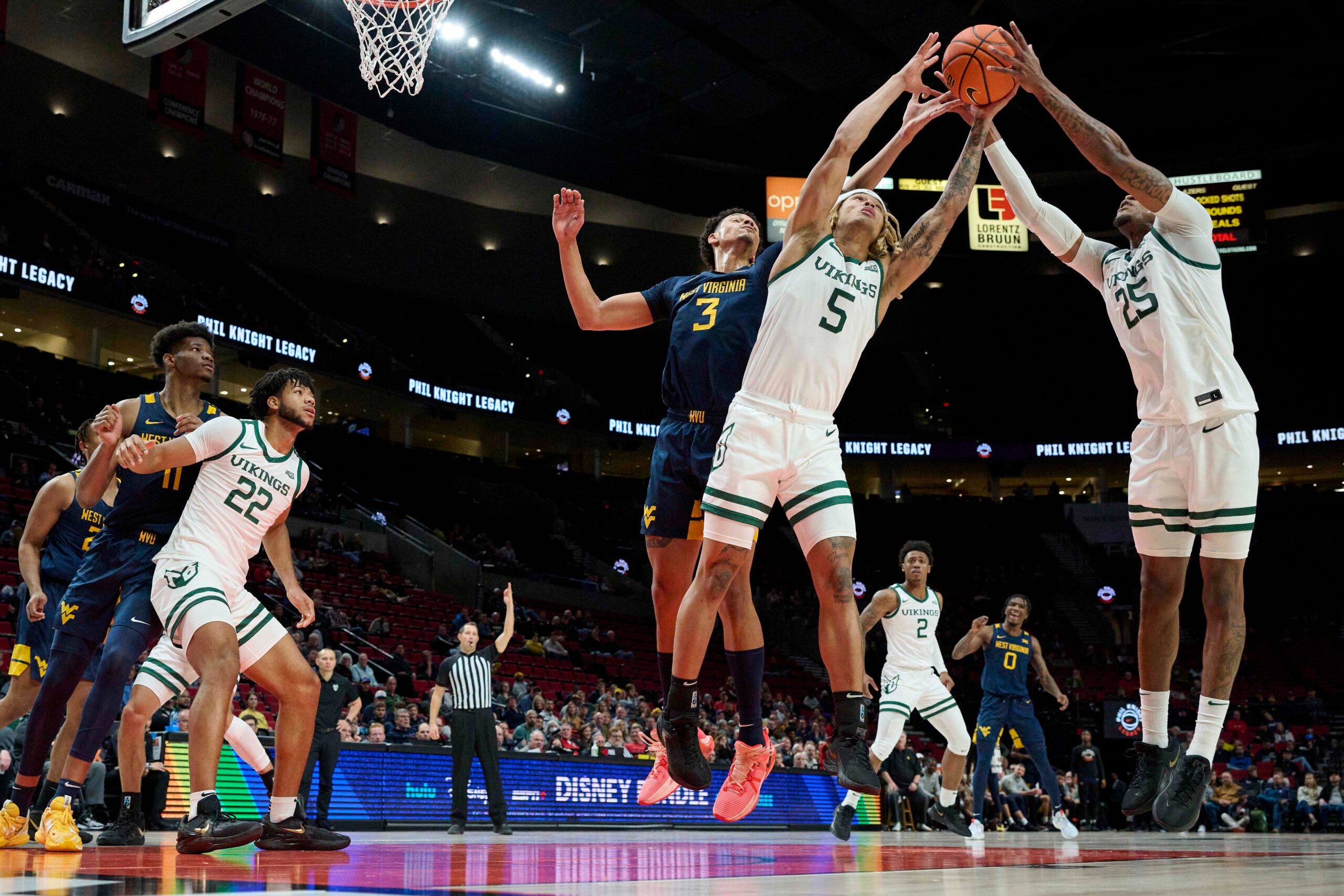 Nov 25, 2022; Portland, Oregon, USA; Portland State Vikings guard Isiah Kirby (5) and guard Hunter Woods (25) grab a rebound during the first half against West Virginia Mountaineers forward Tre Mitchell (3) at Moda Center. Mandatory Credit: Troy Wayrynen-Imagn Images