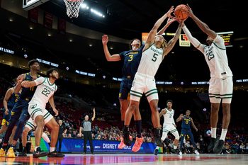 Nov 25, 2022; Portland, Oregon, USA; Portland State Vikings guard Isiah Kirby (5) and guard Hunter Woods (25) grab a rebound during the first half against West Virginia Mountaineers forward Tre Mitchell (3) at Moda Center. Mandatory Credit: Troy Wayrynen-Imagn Images