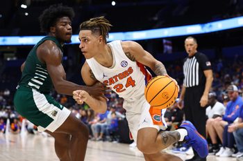 Dec 14, 2022; Tampa, Florida, USA;Florida Gators guard Riley Kugel (24) drives to the basket as Ohio Bobcats guard Elmore James (1) defends  during the second half at Amalie Arena. Mandatory Credit: Kim Klement-Imagn Images