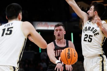 Davidson Wildcats guard Foster Loyer (0) passes the ball during the Indy Classic NCAA men   s basketball doubleheader against the Purdue Boilermakers, Saturday, Dec. 17, 2022, at Gainbridge Fieldhouse in Indianapolis. Purdue won 69-61.

Purduedavidsonmbb121722 Am14189