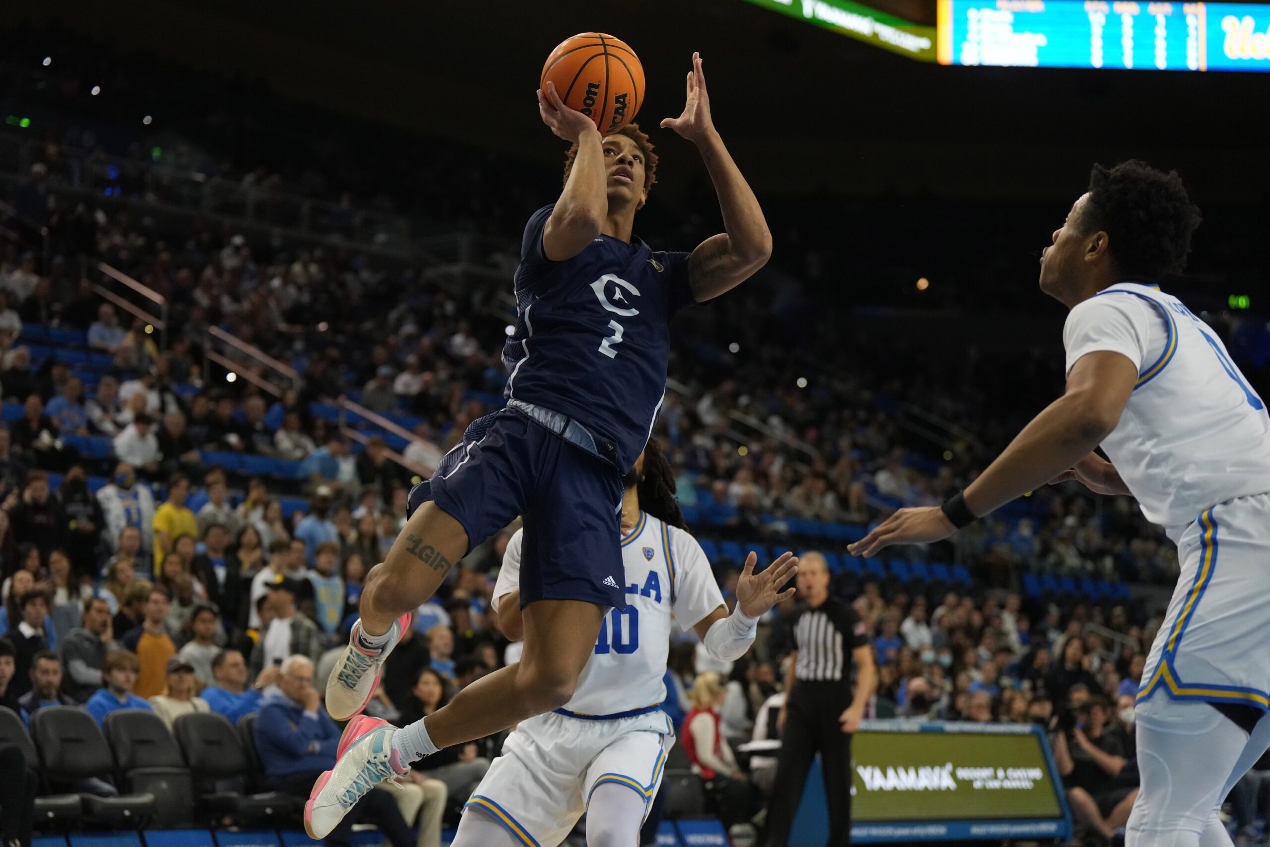 Dec 21, 2022; Los Angeles, California, USA; UC Davis Aggies guard Ty Johnson (2) shoots the ball against UCLA Bruins in the first half at Pauley Pavilion presented by Wescom. Mandatory Credit: Kirby Lee-Imagn Images