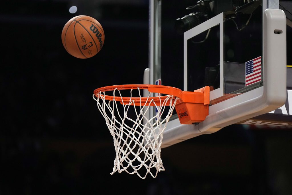 Feb 23, 2023; Los Angeles, California, USA; A Wilson official NBA basketball swishes through the net at Crypto.com Arena. Mandatory Credit: Kirby Lee-Imagn Images
