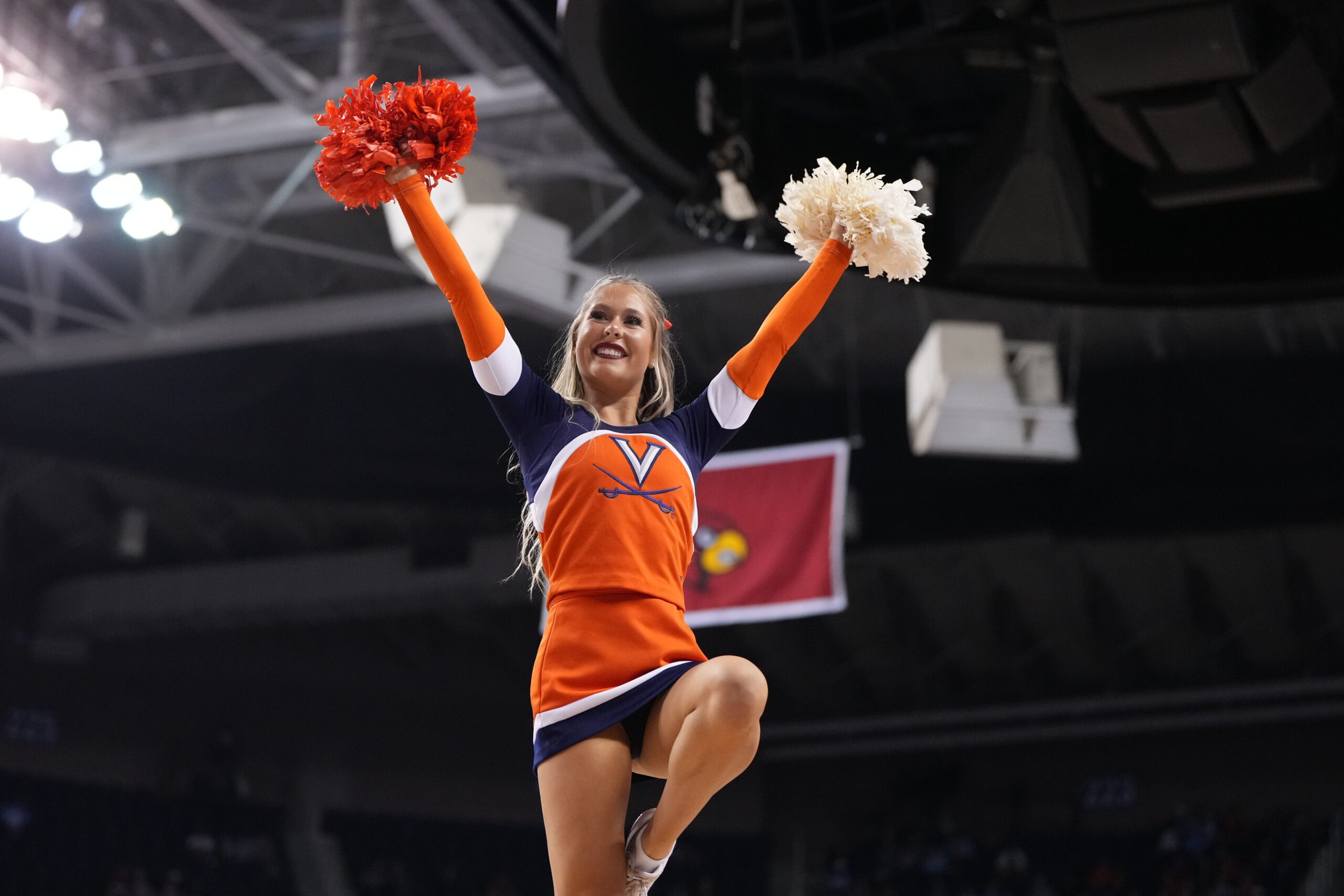 Mar 9, 2023; Greensboro, NC, USA; Virginia Cavaliers cheerleader performs in the second half of the quarterfinals of the ACC tournament at Greensboro Coliseum.  Mandatory Credit: Bob Donnan-Imagn Images