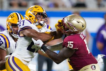Florida State Seminoles linebacker Tatum Bethune (15) fights off LSU Tigers running back Josh Williams (27) during a game at Camping World Stadium on Sunday, Sept. 3, 2023.