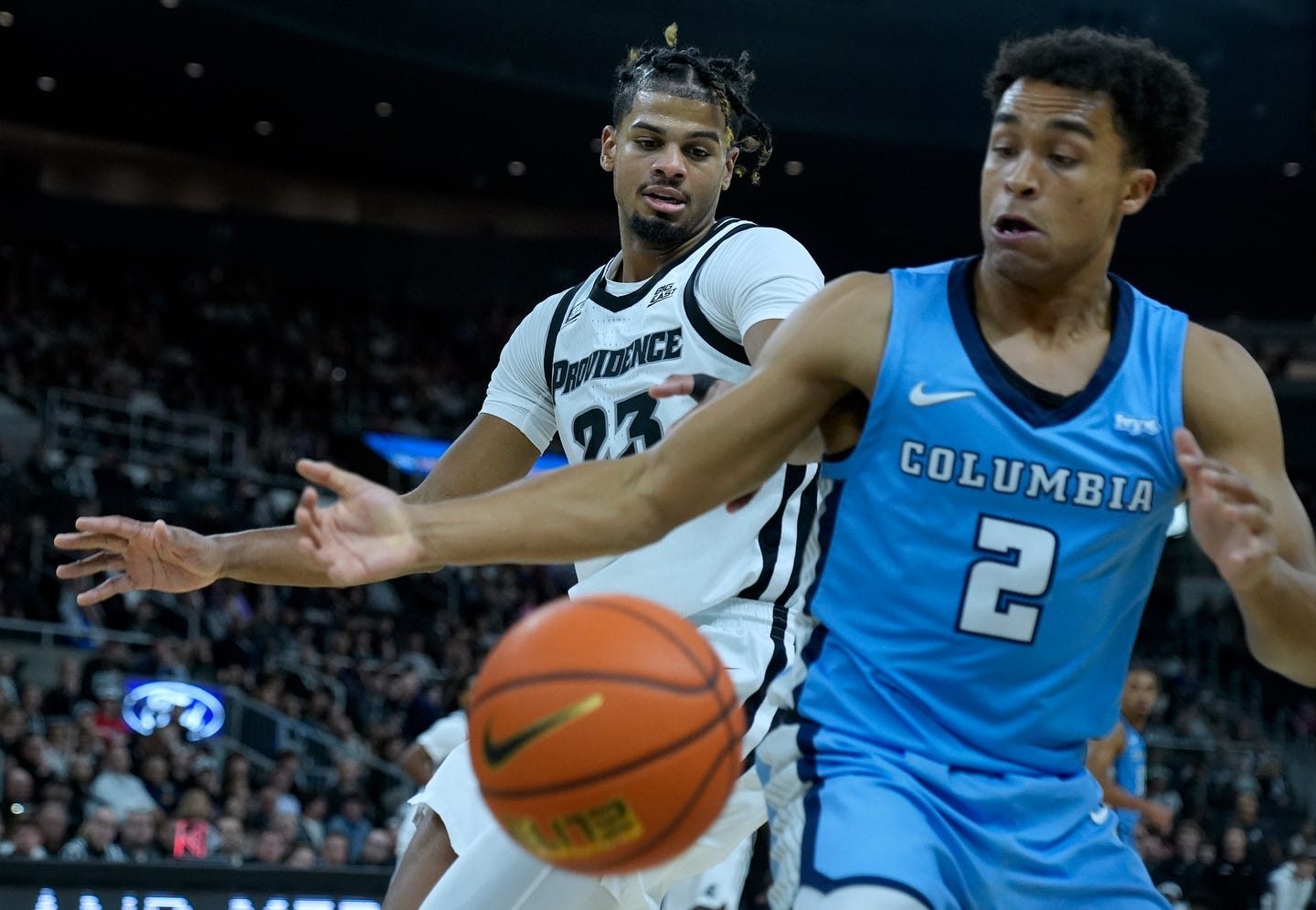 Friar Bryce Hopkins and Lion Kenny Noland watch as a knocked ball heads out of bounds in the first half.