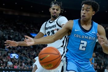 Friar Bryce Hopkins and Lion Kenny Noland watch as a knocked ball heads out of bounds in the first half.