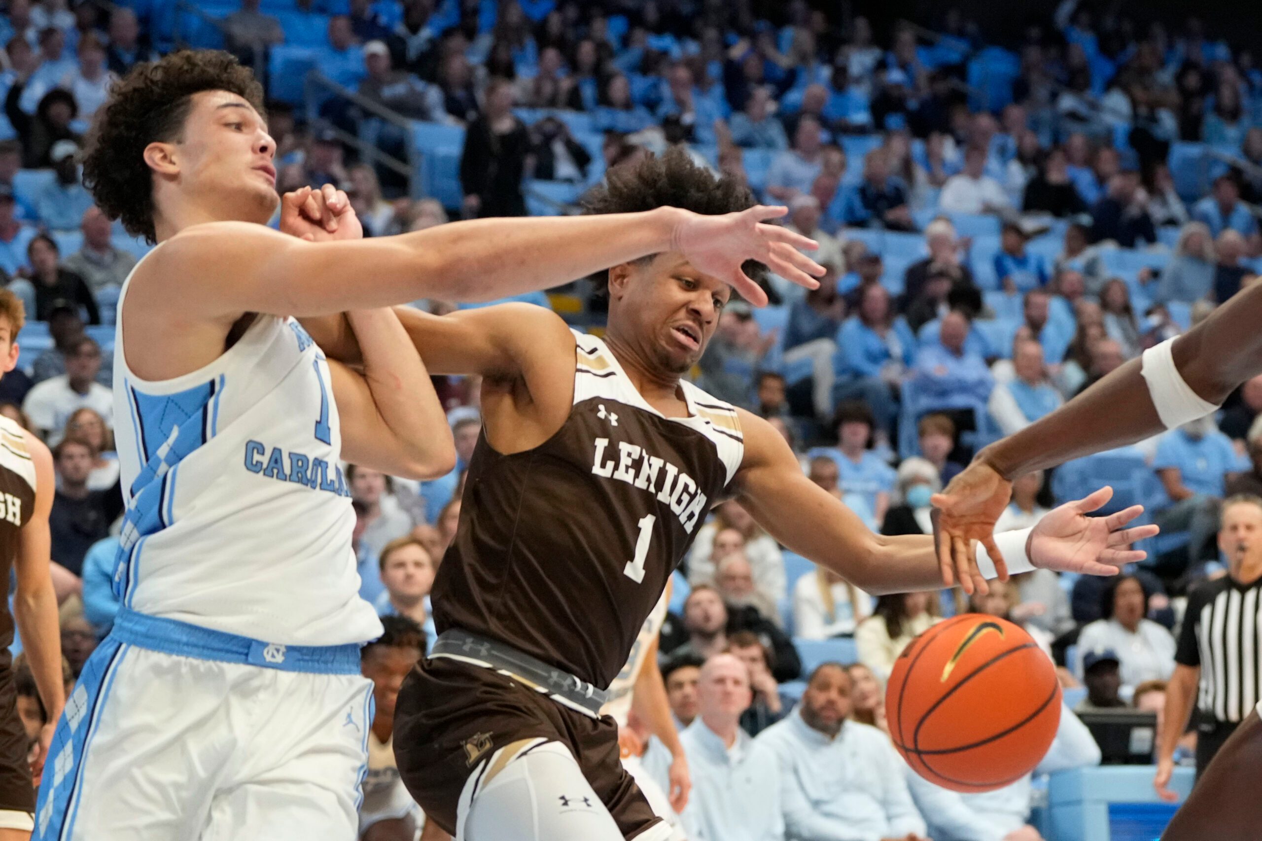 Nov 12, 2023; Chapel Hill, North Carolina, USA; North Carolina Tar Heels forward Zayden High (1) and Lehigh Mountain Hawks guard Nasir Whitlock (1) fight for the ball in the second half at Dean E. Smith Center. Mandatory Credit: Bob Donnan-Imagn Images