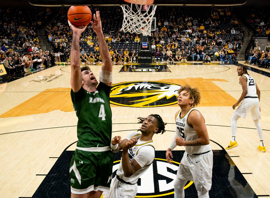 Nov 25, 2023; Columbia, Missouri, USA; Loyola (Md) Greyhounds forward Alonso Faure (4) shoots against Missouri Tigers guard Sean East II (55) and forward Noah Carter (35) during the second half at Mizzou Arena. Mandatory Credit: Jay Biggerstaff-Imagn Images
