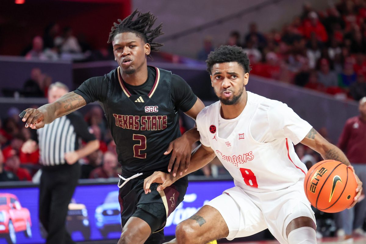 Dec 21, 2023; Houston, Texas, USA; Houston Cougars guard Mylik Wilson (8) dribbles against Texas State Bobcats guard Dontae Horne (2) in the second half at Fertitta Center. Mandatory Credit: Thomas Shea-Imagn Images
