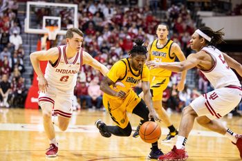 Dec 29, 2023; Bloomington, Indiana, USA; Kennesaw State Owls guard Terrell Burden (1) dribbles the ball while Indiana Hoosiers guard Gabe Cupps (2) and forward Malik Reneau (5) defend in the second half at Simon Skjodt Assembly Hall. Mandatory Credit: Trevor Ruszkowski-Imagn Images
