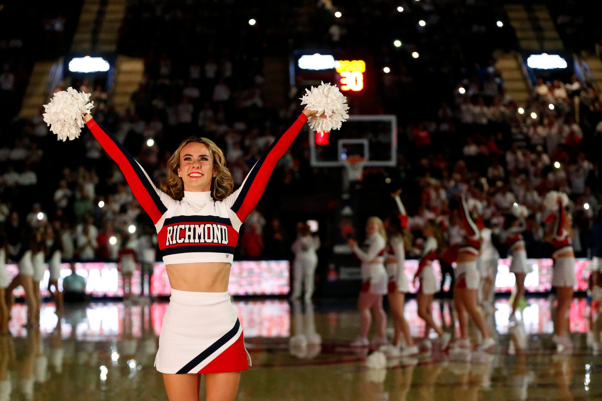 Jan 27, 2024; Richmond, Virginia, USA; A Richmond Spiders cheerleader looks on from the court prior to the Spiders' game against the Dayton Flyers during the first half at the Robins Center. Mandatory Credit: Amber Searls-Imagn Images