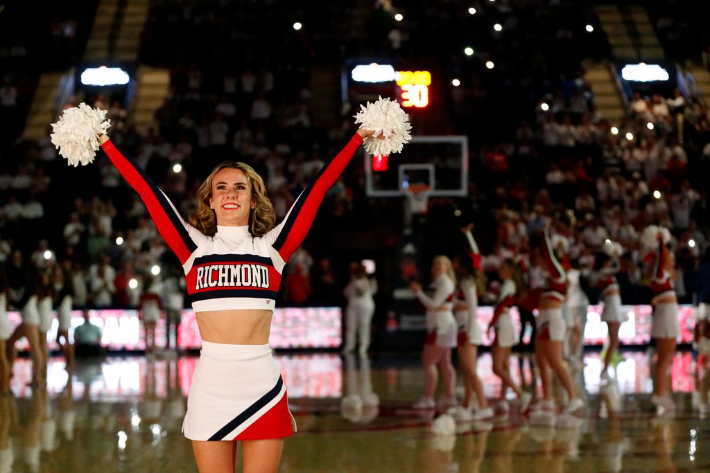Jan 27, 2024; Richmond, Virginia, USA; A Richmond Spiders cheerleader looks on from the court prior to the Spiders' game against the Dayton Flyers during the first half at the Robins Center. Mandatory Credit: Amber Searls-Imagn Images