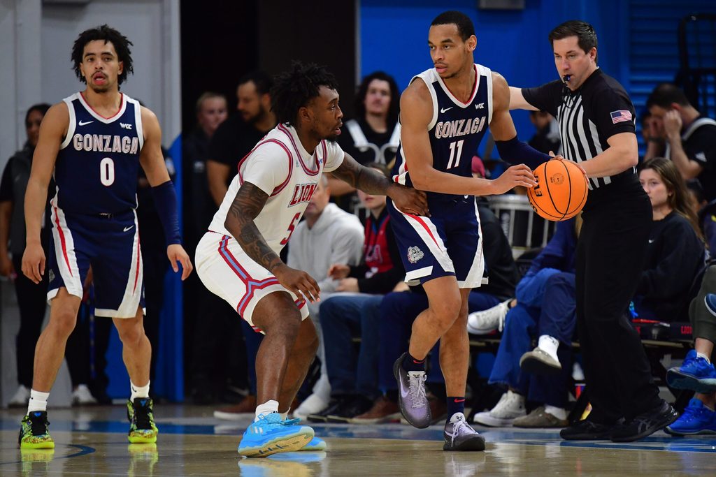 Feb 15, 2024; Los Angeles, California, USA; Gonzaga Bulldogs guard Nolan Hickman (11) moves the ball against Loyola Marymount Lions guard Justin Wright (5) during the second half at Gersten Pavilion. Mandatory Credit: Gary A. Vasquez-Imagn Images