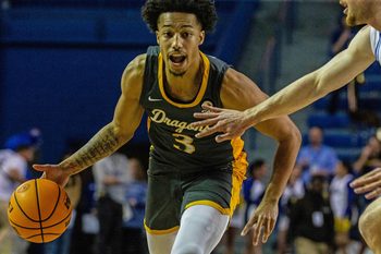 Drexel Dragons guard Jamie Bergens (3) dribbles against the Delaware Fightin' Blue Hens guard Christian Ray (5) during critical late-season CAA basketball game at the Bob Carpenter Center in Newark, Monday, Feb. 26, 2024. Drexel won 70-60.