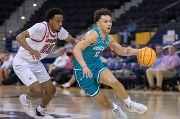 Jacob Meyer (12) brings the ball up court during the Coastal Carolina University vs University of Louisiana at Lafayette basketball game in the second round of the Sun Belt Conference Men's Basketball Championship at the Pensacola Bay Center on Thursday, March 7, 2024.