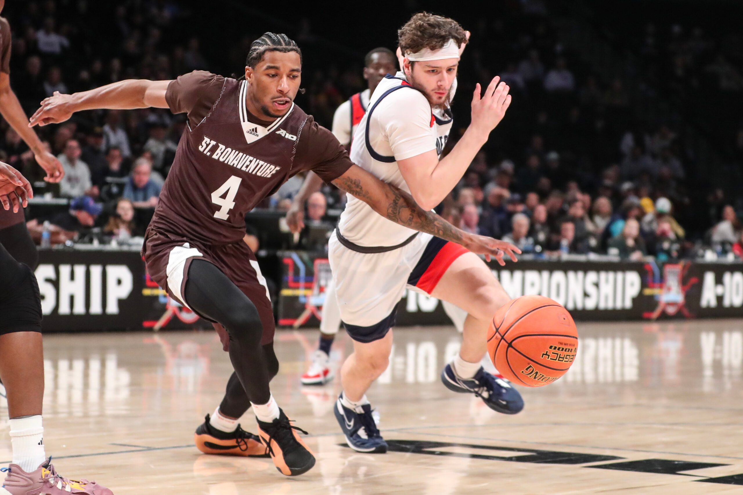 Mar 16, 2024; Brooklyn, NY, USA;  St. Bonaventure Bonnies guard Moses Flowers (4) and Duquesne Dukes guard Jake DiMichele (44) fight for a loose ball in the first half at Barclays Center. Mandatory Credit: Wendell Cruz-Imagn Images