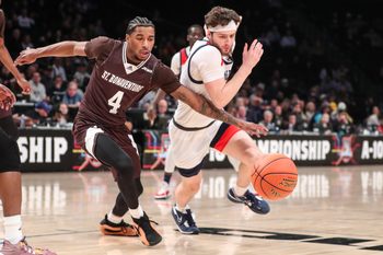 Mar 16, 2024; Brooklyn, NY, USA;  St. Bonaventure Bonnies guard Moses Flowers (4) and Duquesne Dukes guard Jake DiMichele (44) fight for a loose ball in the first half at Barclays Center. Mandatory Credit: Wendell Cruz-Imagn Images