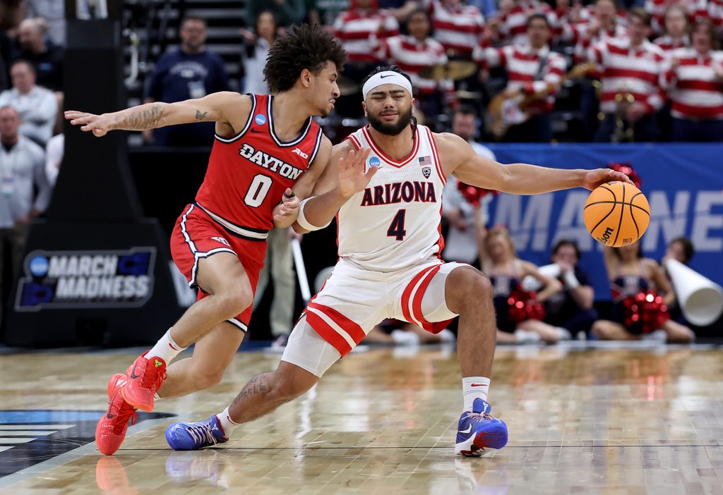 Mar 23, 2024; Salt Lake City, UT, USA; Arizona Wildcats guard Kylan Boswell (4) dribbles against Dayton Flyers guard Javon Bennett (0) during the first half in the second round of the 2024 NCAA Tournament at Vivint Smart Home Arena-Delta Center. Mandatory Credit: Rob Gray-Imagn Images