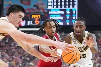 Purdue Boilermakers center Zach Edey (15), North Carolina State Wolfpack guard Breon Pass (10) and Purdue Boilermakers guard Lance Jones (55) go for the ball during the NCAA Menâ€™s Basketball Tournament Final Four game, Saturday, April 6, 2024, at State Farm Stadium in Glendale, Ariz.