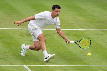 Jul 1, 2024; London, United Kingdom; Alex Bolt of Australia returns a shot during his match against Casper Ruud of Norway (not shown) on day one of The Championships at All England Lawn Tennis and Croquet Club. Mandatory Credit: Susan Mullane-Imagn Images