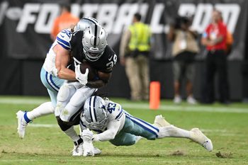 Aug 17, 2024; Paradise, Nevada, USA; Las Vegas Raiders running back Brittain Brown (38) is tackled by Dallas Cowboys linebacker Willie Harvey Jr. (55) and cornerback Kemon Hall (43) in the fourth quarter at Allegiant Stadium. Mandatory Credit: Candice Ward-Imagn Images